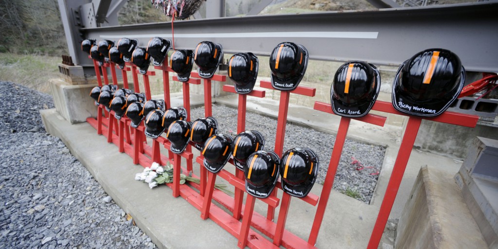 Mine helmets and painted crosses sit at the entrance to Massey Energy's Upper Big Branch coal mine Tuesday, April 5, 2011 in Montcoal, W.Va. The memorial represents the 29 coal miners who were killed in an explosion at the mine one year ago today. (AP Photo/Jeff Gentner)